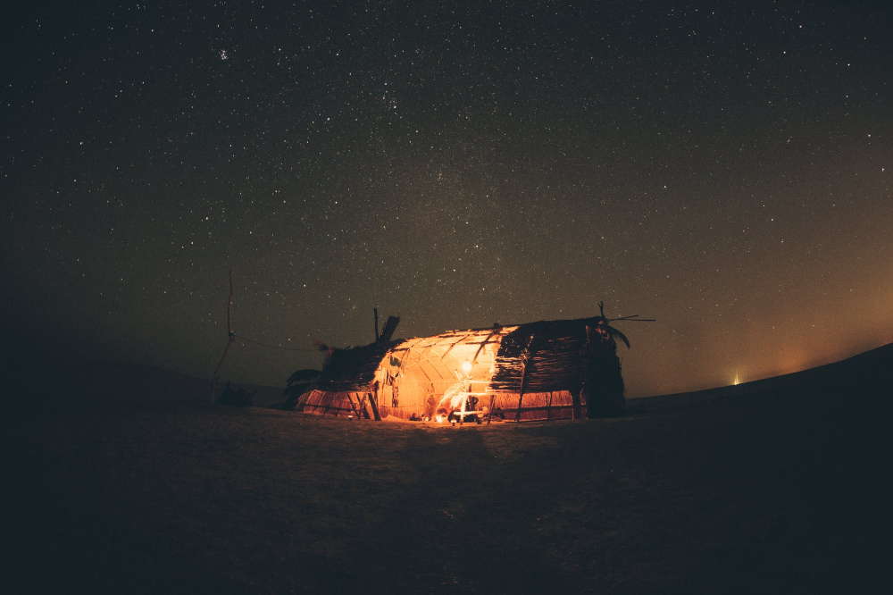primitive camping tent in the night
