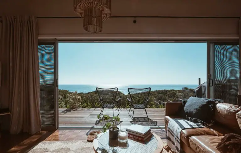 Image of a luxury hotel room with oceanfront view, showcasing a spacious room with a private balcony and upscale amenities like spa and fine dining